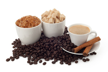 Cup of coffee and beans with sugar and cinnamon