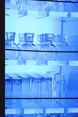 Naklejka premium Bar glasses in a blue light