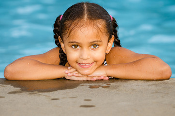 Portrait of happy pretty mixed race child by side of pool  © Robert Hainer