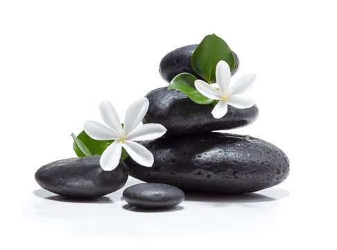 tiare flowers, candle and black stone spa