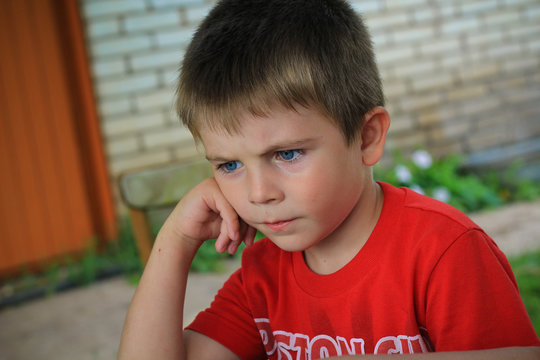 little boy deep in thoughts