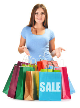 Young happy woman with colorful paper shopping bags isolated