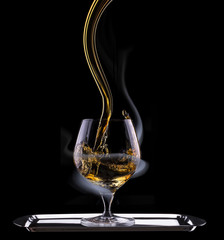 Cognac glass shrouded in a smoke