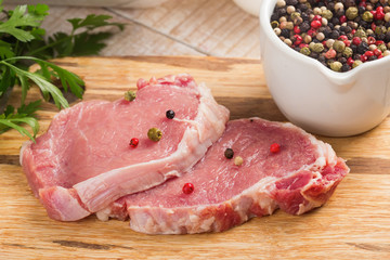 Fresh raw meat on wooden background with pepper