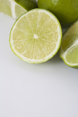 Fototapeta na wymiar Whole and sliced limes