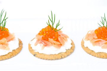 appetizer crackers with cream cheese, salmon and red caviar