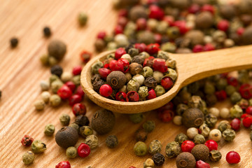 Peppercorn mix in a wooden spoon