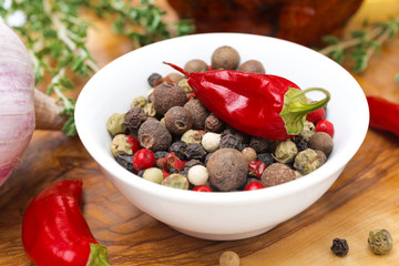 Assorted hot peppers in a bowl and fresh chili peppers, close-up