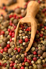 Peppercorn mix in a wooden spoon
