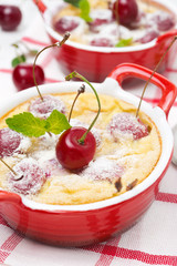Casserole (clafoutis) with cherry in the ramekin, close-up