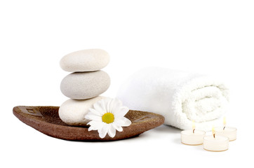 spa decoration with stones, daisies and candles