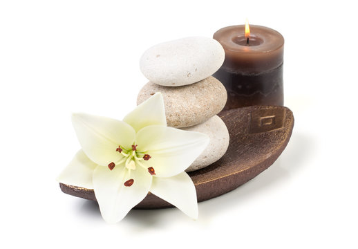 spa decoration with stones, candle and madonna lily