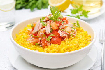 saffron rice with tuna, tomatoes, peppers and herbs in a bowl