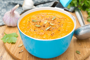 spicy pumpkin soup with coriander in a saucepan