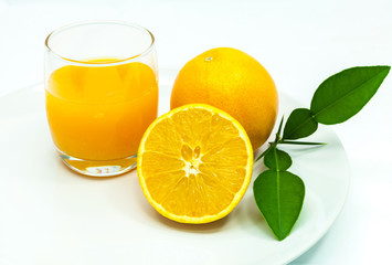 Glass of fresh orange juice with sliced orange .