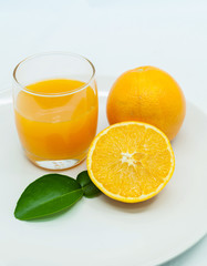 Glass of fresh orange juice with sliced orange .