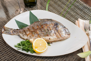 fresh fish cooked on the grill served on a platter