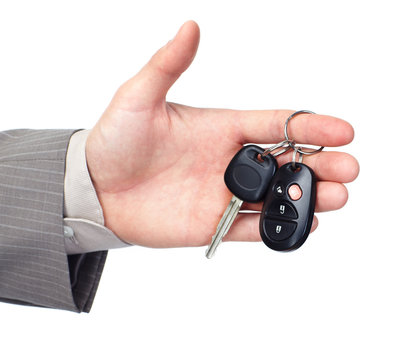 Hand giving a car key.