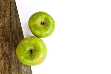 Green apples and white paper