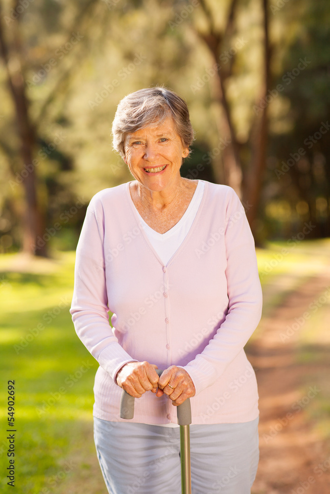 Sticker happy senior woman outdoors in forest