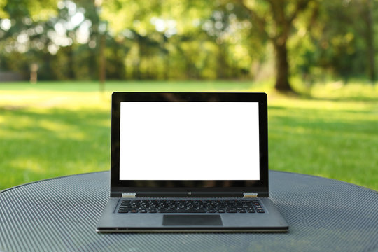 Laptop with blank screen outdoors