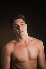 Fototapeta premium Beauty image of glam guy. Face close-up. Isolated on black.