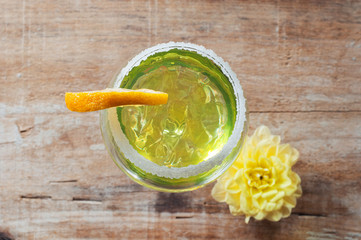 Lemon cocktail in a glass on wooden background