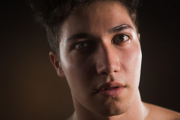 Fototapeta premium Beauty image of glam guy. Face close-up. Isolated on black.