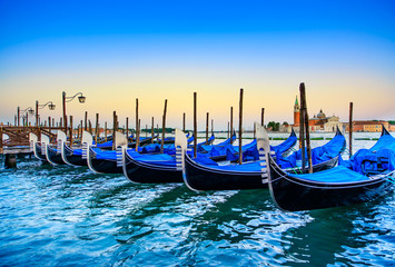 Venice, gondolas or gondole on sunset. Italy