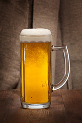 Beautiful glass mug of beer on the table