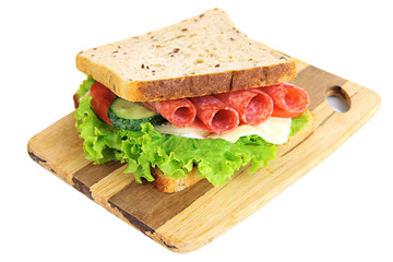 Tasty sandwich with salami sausage and vegetables