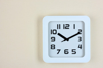 Office clock on color wall background