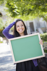 Fototapeta premium Excited Mixed Race Female Student Holding Blank Chalkboard
