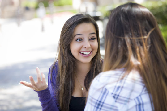 Expressive Young Mixed Race Female Sitting and Talking with Girl