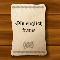 Old medieval parchment paper on wood background