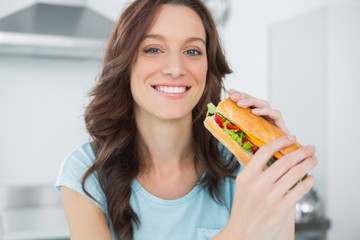 Pretty brunette having sandwich