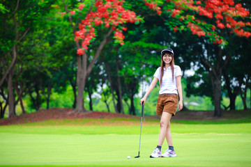 Smiling asian woman golfer