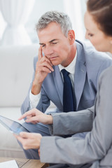 Smiling businessman working with his colleague