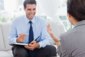 Smiling businessman talking to his colleague