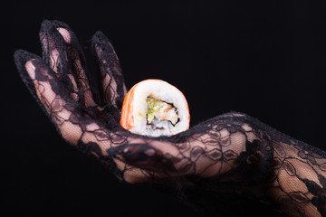 hand holding a colorful sushi