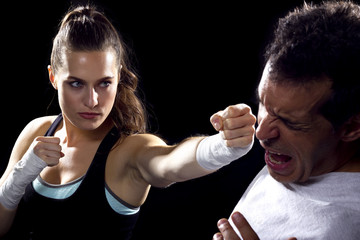 female MMA fighter fighting a man