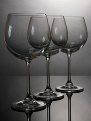 Empty wine glasses arranged on grey background