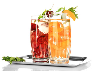 Glasses of fruit drinks with ice cubes isolated on white