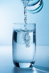 Pouring water into glass