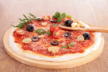 pizza dough with tomato sauce and ingredients
