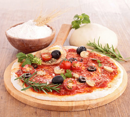 pizza dough with tomato sauce and ingredients