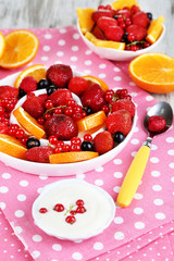 Useful fruit salad in plates on wooden table close-up