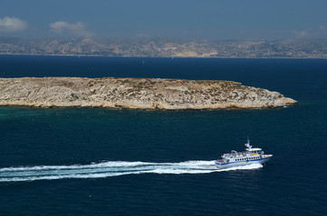 Small boat leaving fortress If next to harbor of Marseille