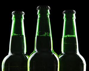 Bottles of beer on black background