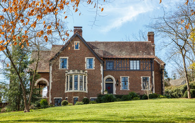 Old Brick House with Classic Windows on Green Grass
